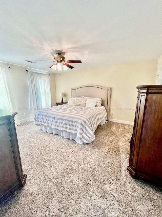 305 Chris Ln, Winfield, AL 35594 - bedroom featuring baseboards, visible vents, a ceiling fan, and light carpet