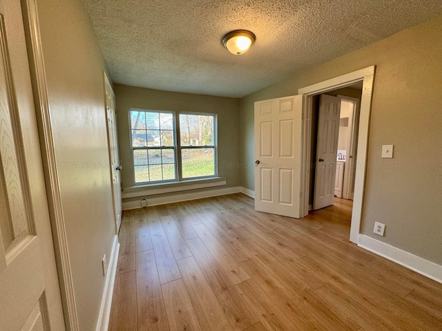 1532 SW Bay Ave, Birmingham, AL 35211 - unfurnished bedroom with light wood-type flooring and a textured ceiling