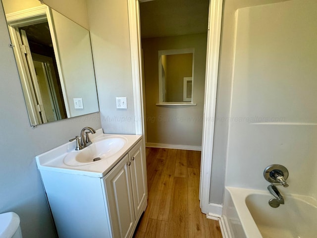 1532 SW Bay Ave, Birmingham, AL 35211 - full bathroom with wood finished floors, vanity, and shower / bath combination