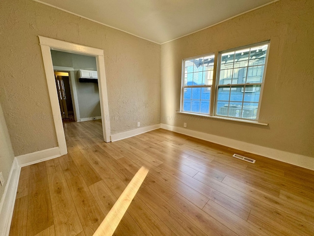 1532 SW Bay Ave, Birmingham, AL 35211 - unfurnished room featuring hardwood / wood-style flooring and a textured wall