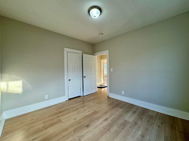 1532 SW Bay Ave, Birmingham, AL 35211 - unfurnished bedroom with light wood finished floors and a closet