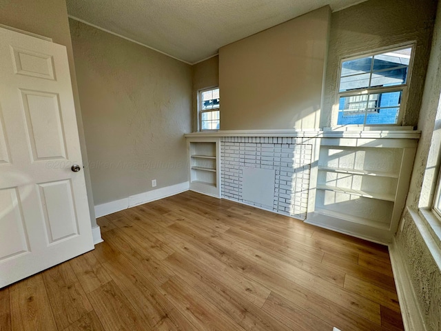 1532 SW Bay Ave, Birmingham, AL 35211 - unfurnished room with wood finished floors, a textured ceiling, and a textured wall