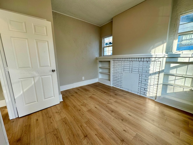 1532 SW Bay Ave, Birmingham, AL 35211 - empty room with wood finished floors, a textured ceiling, and a textured wall
