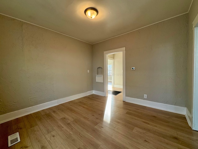 1532 SW Bay Ave, Birmingham, AL 35211 - empty room with wood finished floors and a textured wall