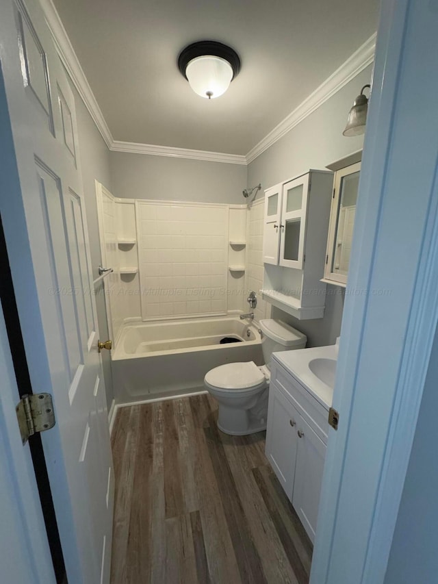 bathroom with vanity, crown molding, toilet, shower / bathtub combination, and wood finished floors