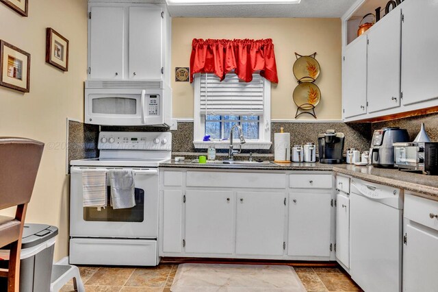 2555 Shady Rd, Adamsville, AL 35005 - kitchen featuring white appliances, decorative backsplash, and white cabinets