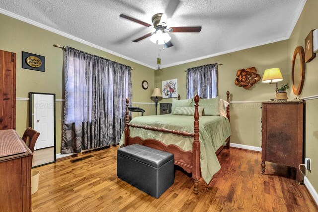 2555 Shady Rd, Adamsville, AL 35005 - bedroom featuring a textured ceiling, wood finished floors, ornamental molding, and ceiling fan