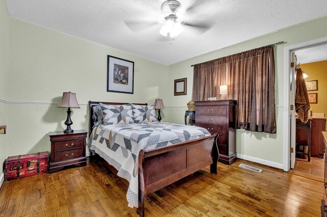 2555 Shady Rd, Adamsville, AL 35005 - bedroom with wood finished floors, a textured ceiling, and ceiling fan