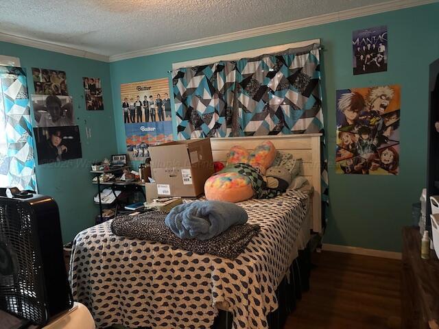 1619 14th Ave, Haleyville, AL 35565 - bedroom featuring wood finished floors, ornamental molding, and a textured ceiling