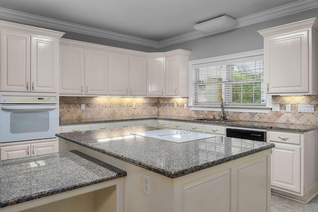 5746 Old Birmingham Hwy, Jasper, AL 35501 - kitchen featuring white oven, cooktop, a center island, dark stone counters, and tasteful backsplash