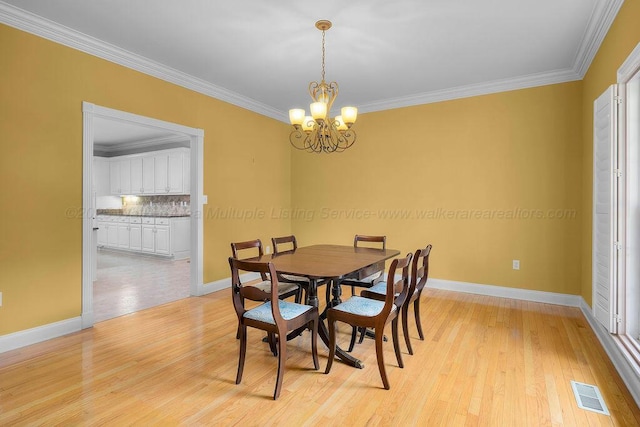5746 Old Birmingham Hwy, Jasper, AL 35501 - dining space with a chandelier, ornamental molding, and light wood-type flooring