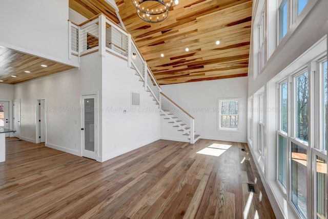 556 Sipsey Rock Rd, Crane Hill, AL 35053 - unfurnished living room featuring wooden ceiling, high vaulted ceiling, stairs, and wood finished floors