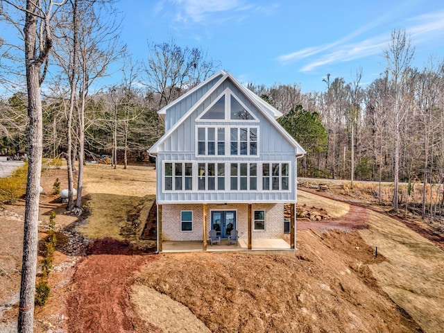 556 Sipsey Rock Rd, Crane Hill, AL 35053 - back of property with french doors, board and batten siding, brick siding, and a patio