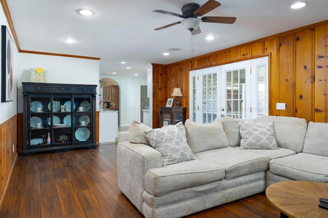 living room featuring dark hardwood / wood-style flooring, ceiling fan, crown molding, and french doors