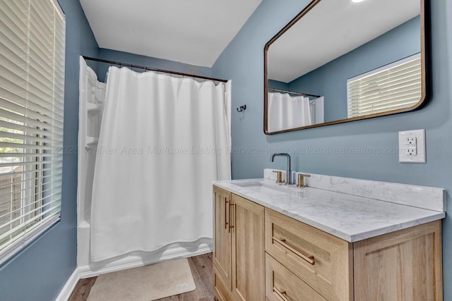 242 County Rd 307, Cullman, AL 35057 - bathroom with wood finished floors, vanity, shower / bath combo with shower curtain, and baseboards