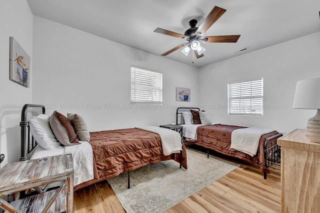 242 County Rd 307, Cullman, AL 35057 - bedroom with multiple windows, light wood finished floors, and a ceiling fan