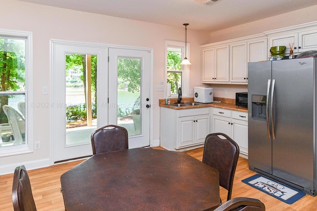 1528 Sipsey Rd, Double Springs, AL 35553 - kitchen featuring stainless steel fridge, plenty of natural light, white cabinetry, black microwave, and a sink