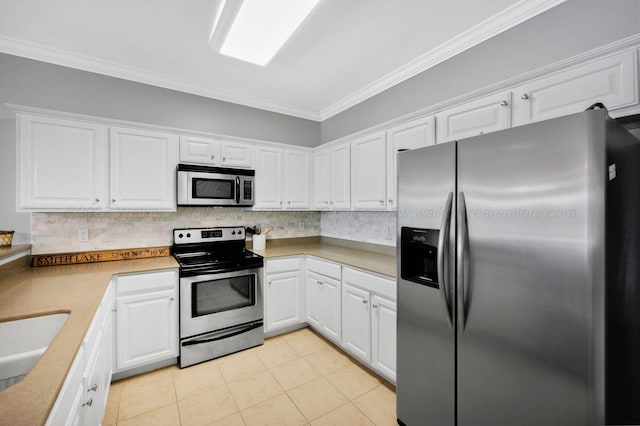 9661 Curry Hwy, Jasper, AL 35503 - kitchen with appliances with stainless steel finishes, ornamental molding, backsplash, and white cabinetry