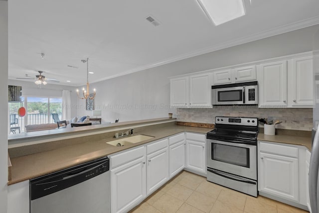 9661 Curry Hwy, Jasper, AL 35503 - kitchen with appliances with stainless steel finishes, a sink, white cabinetry, tasteful backsplash, and ornamental molding