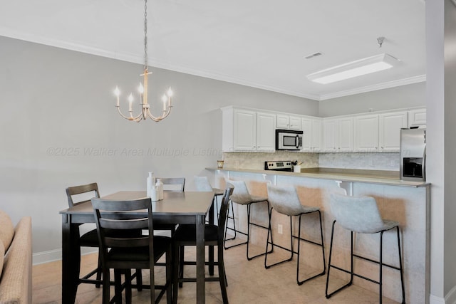 9661 Curry Hwy, Jasper, AL 35503 - kitchen with stainless steel appliances, a chandelier, tasteful backsplash, white cabinets, and crown molding