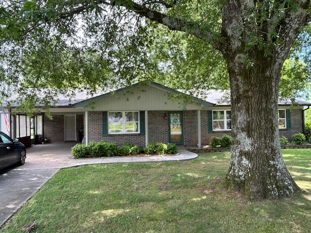 1728 Primrose Dr, Cullman, AL 35055 - single story home with brick siding, concrete driveway, a carport, and a front yard