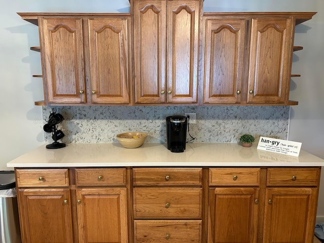 1728 Primrose Dr, Cullman, AL 35055 - kitchen with backsplash, light countertops, and brown cabinets