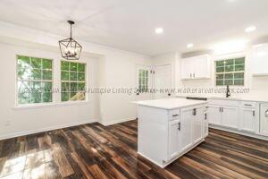 6370 Ball Rd, Mount Olive, AL 35117 - kitchen with a chandelier, white cabinetry, a kitchen island, light countertops, and recessed lighting