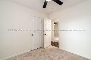 6370 Ball Rd, Mount Olive, AL 35117 - unfurnished bedroom featuring a closet, baseboards, carpet flooring, and ceiling fan