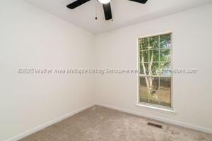 6370 Ball Rd, Mount Olive, AL 35117 - empty room with a ceiling fan, baseboards, and carpet