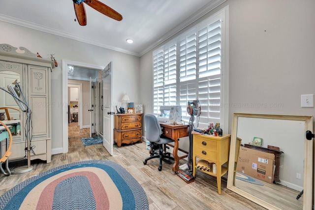 office featuring crown molding, baseboards, ceiling fan, and light wood-style flooring