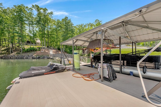 dock area with a water view and boat lift