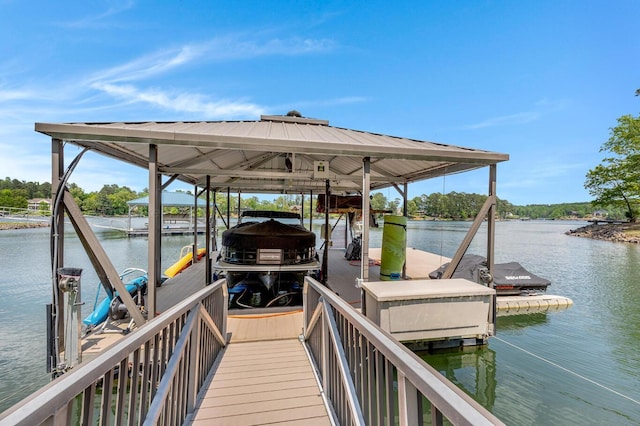 dock area with boat lift and a water view