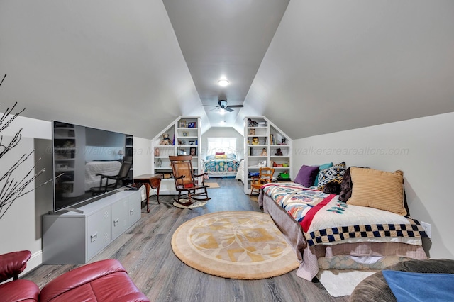 living area featuring a ceiling fan, built in shelves, wood finished floors, and lofted ceiling