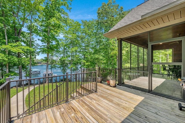 wooden terrace with a lawn and a water view