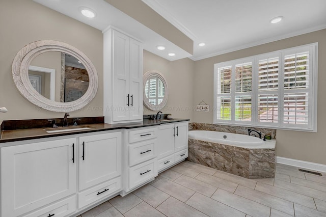 bathroom with a sink, a bath, a wealth of natural light, and ornamental molding