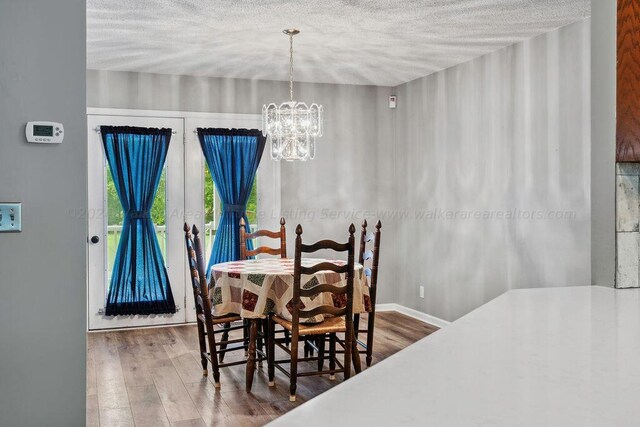 515 River Dr, Quinton, AL 35130 - dining room featuring a textured ceiling, wood finished floors, and an inviting chandelier
