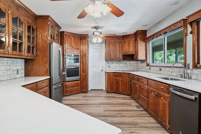 515 River Dr, Quinton, AL 35130 - kitchen featuring light countertops, a sink, light wood-style floors, a ceiling fan, and appliances with stainless steel finishes