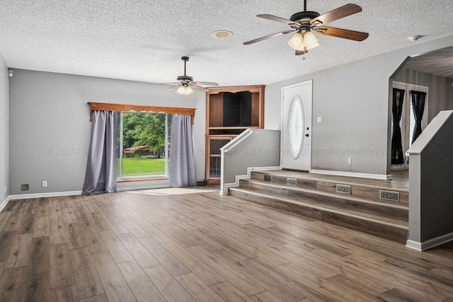 515 River Dr, Quinton, AL 35130 - foyer entrance featuring stairway, a textured ceiling, arched walkways, a ceiling fan, and wood finished floors