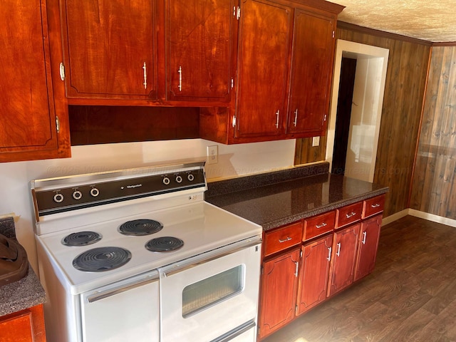 kitchen with double oven range, dark hardwood / wood-style floors, a textured ceiling, dark stone counters, and wood walls