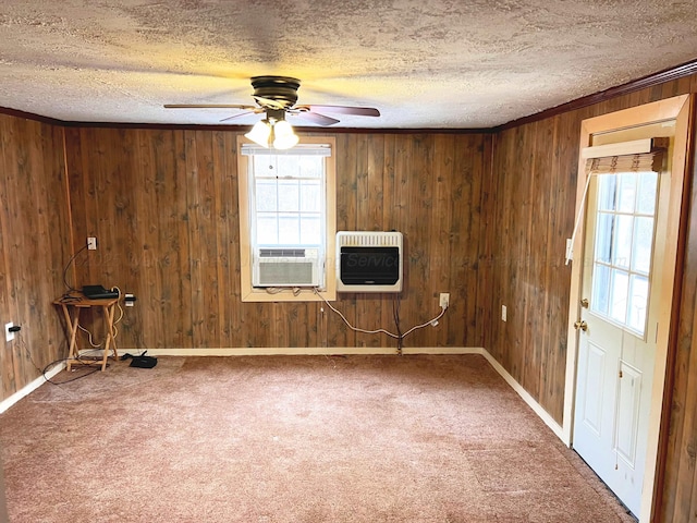 unfurnished room featuring cooling unit, carpet flooring, heating unit, and a textured ceiling