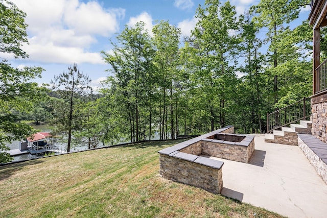 662 Sipsey Pike, Double Springs, AL 35553 - view of green lawn featuring an outdoor fire pit, stairway, and a patio