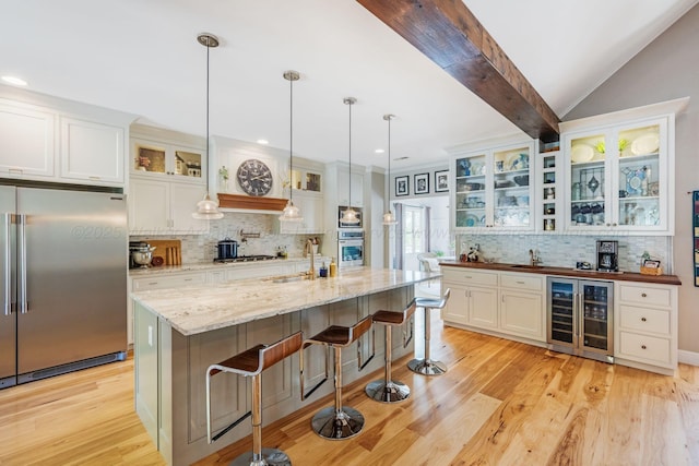 662 Sipsey Pike, Double Springs, AL 35553 - kitchen with appliances with stainless steel finishes, wine cooler, decorative backsplash, light wood finished floors, and recessed lighting