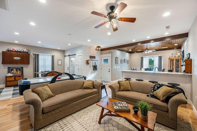 662 Sipsey Pike, Double Springs, AL 35553 - living room featuring recessed lighting, baseboards, ceiling fan, a barn door, and light wood-type flooring