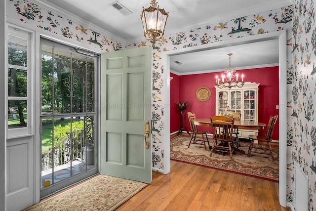 505 3rd Ave, Jasper, AL 35501 - foyer with a chandelier, wood finished floors, crown molding, and wallpapered walls
