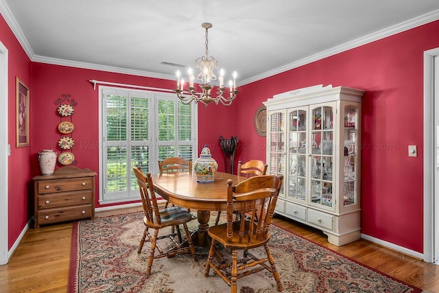 505 3rd Ave, Jasper, AL 35501 - dining area featuring a chandelier, wood finished floors, and ornamental molding