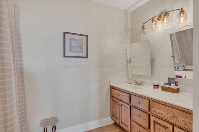 bathroom with tile patterned floors, vanity, and baseboards