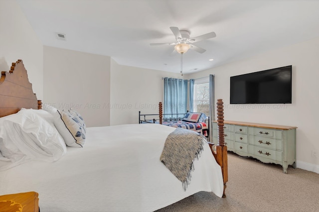 bedroom with light colored carpet, visible vents, ceiling fan, and baseboards