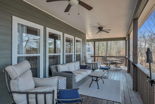 sunroom / solarium featuring outdoor dining area, an outdoor living space, and ceiling fan