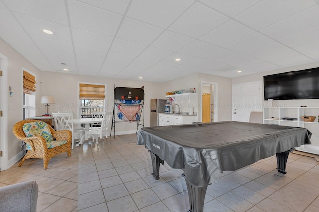 game room with light tile patterned flooring, baseboards, recessed lighting, a drop ceiling, and a sink