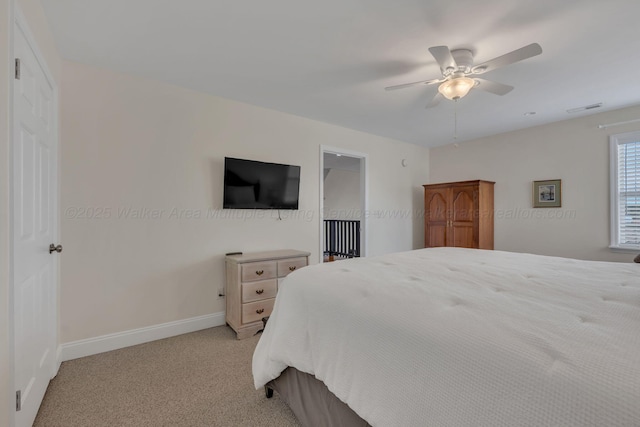 bedroom featuring a ceiling fan, light carpet, baseboards, and visible vents